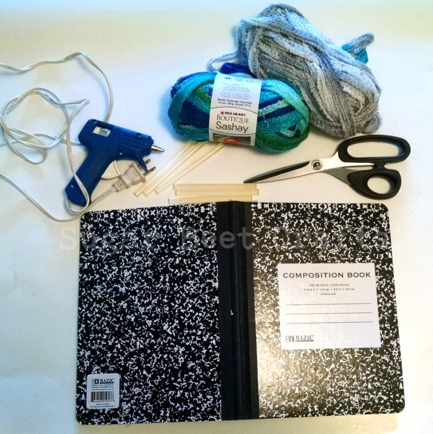 yarn, scissors, glue gun & sticks, notebook